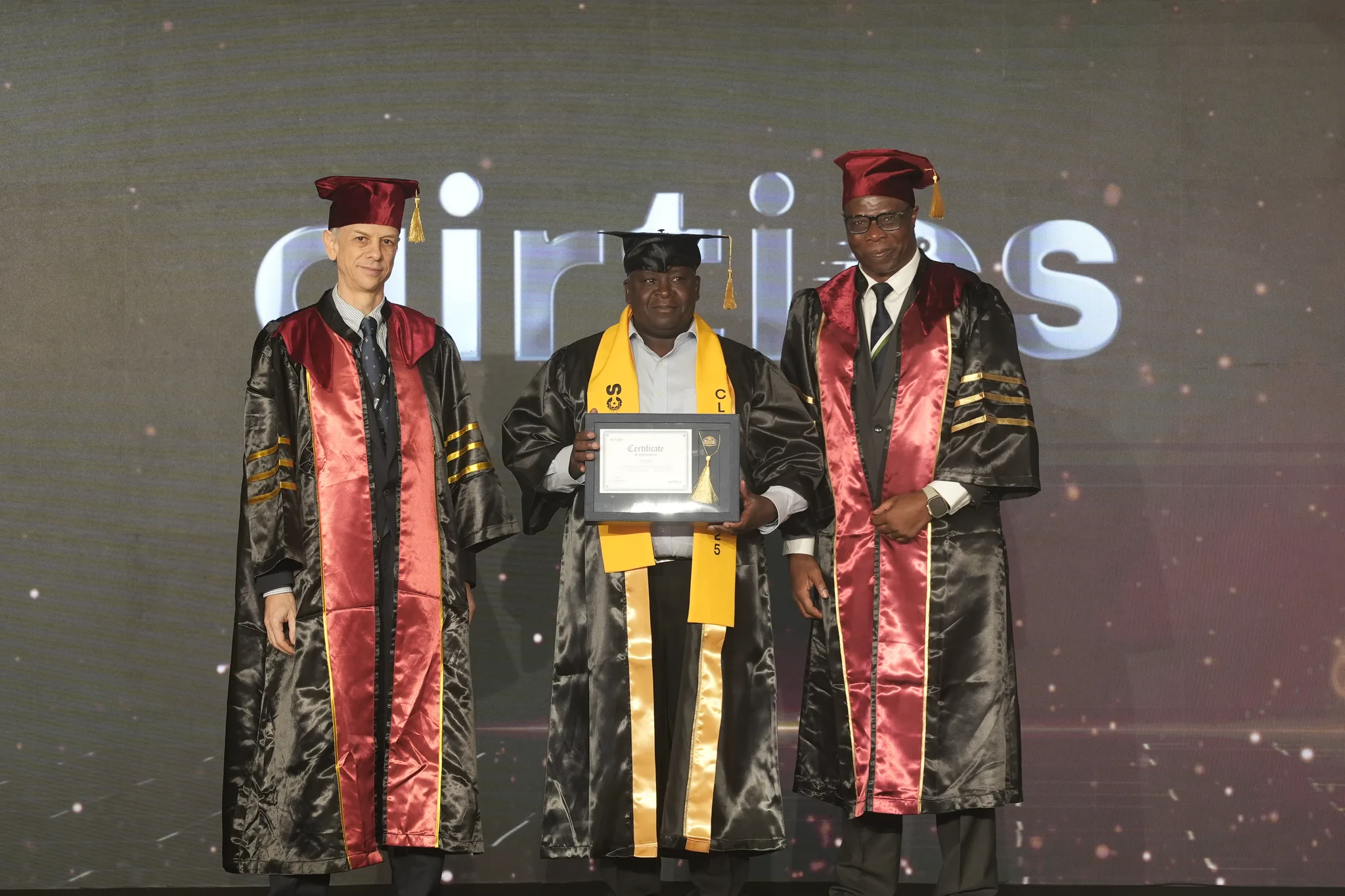 Airtics Graduation 2026: graduate receiving their certificate on stage from the Airtics academic panel