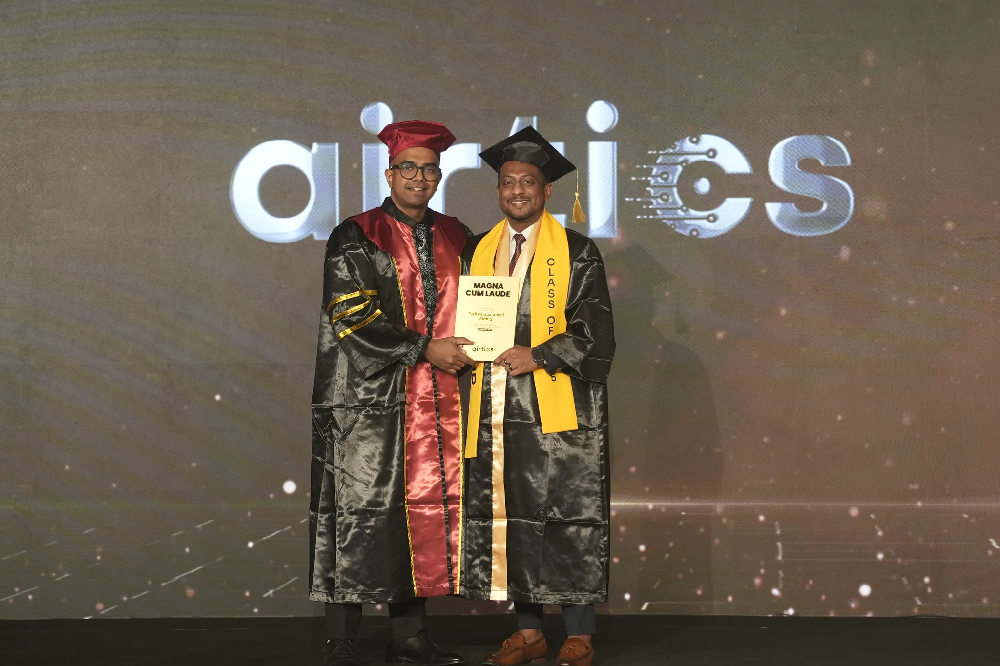 Airtics Graduation 2026: graduate receiving their certificate on stage from the Airtics academic panel