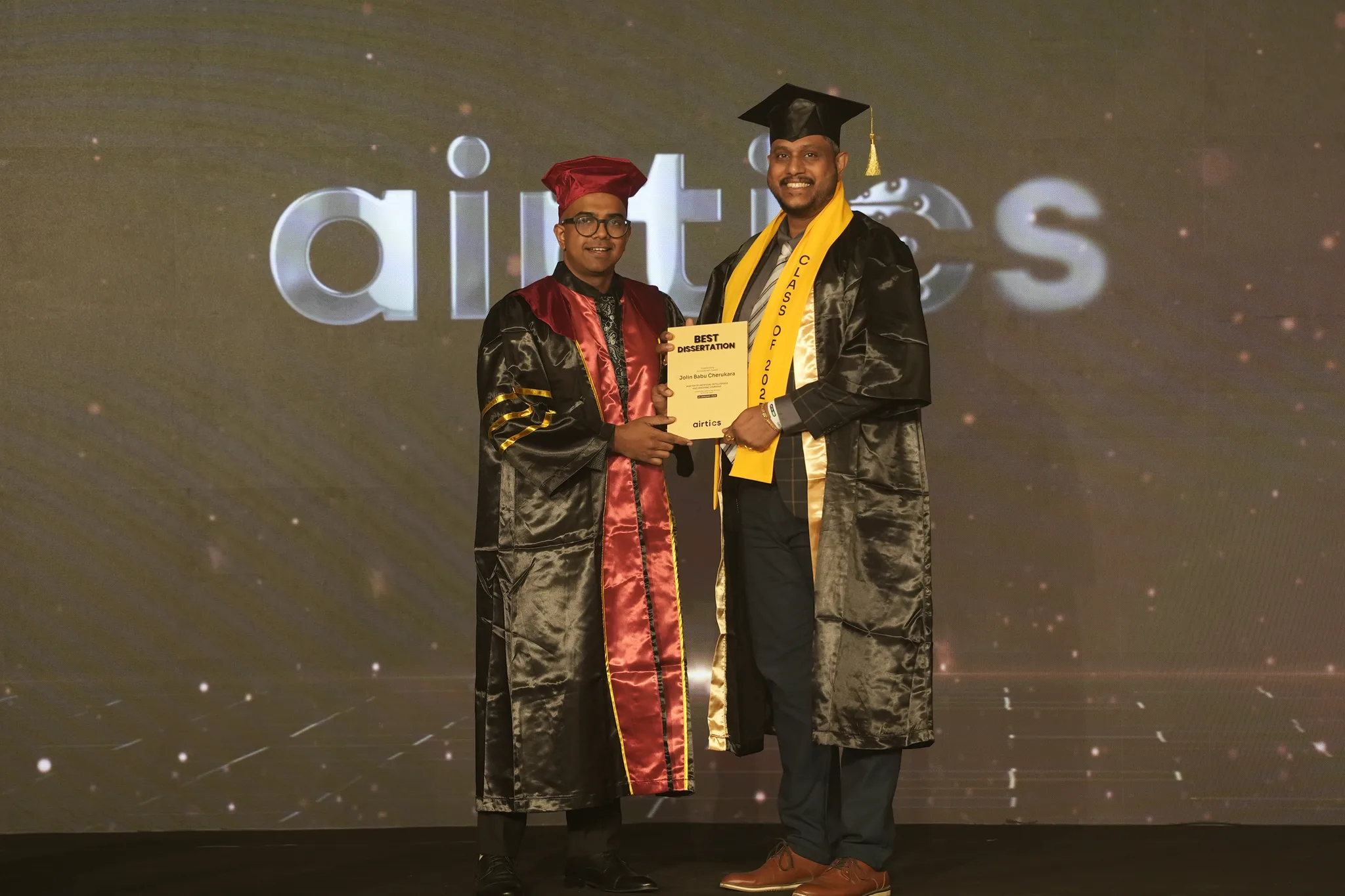 Airtics Graduation 2026: graduate receiving their certificate on stage from the Airtics academic panel