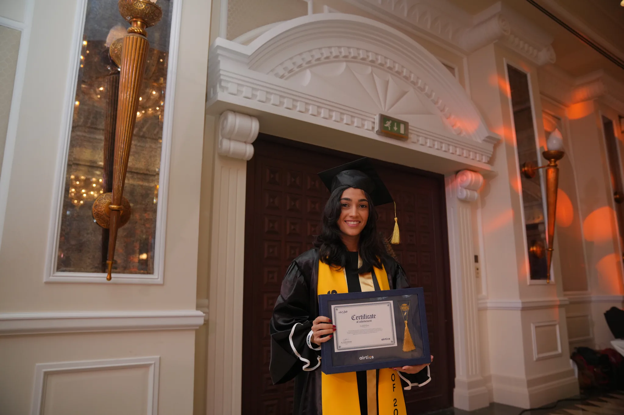 Airtics Graduation 2026: graduate holding their framed certificate