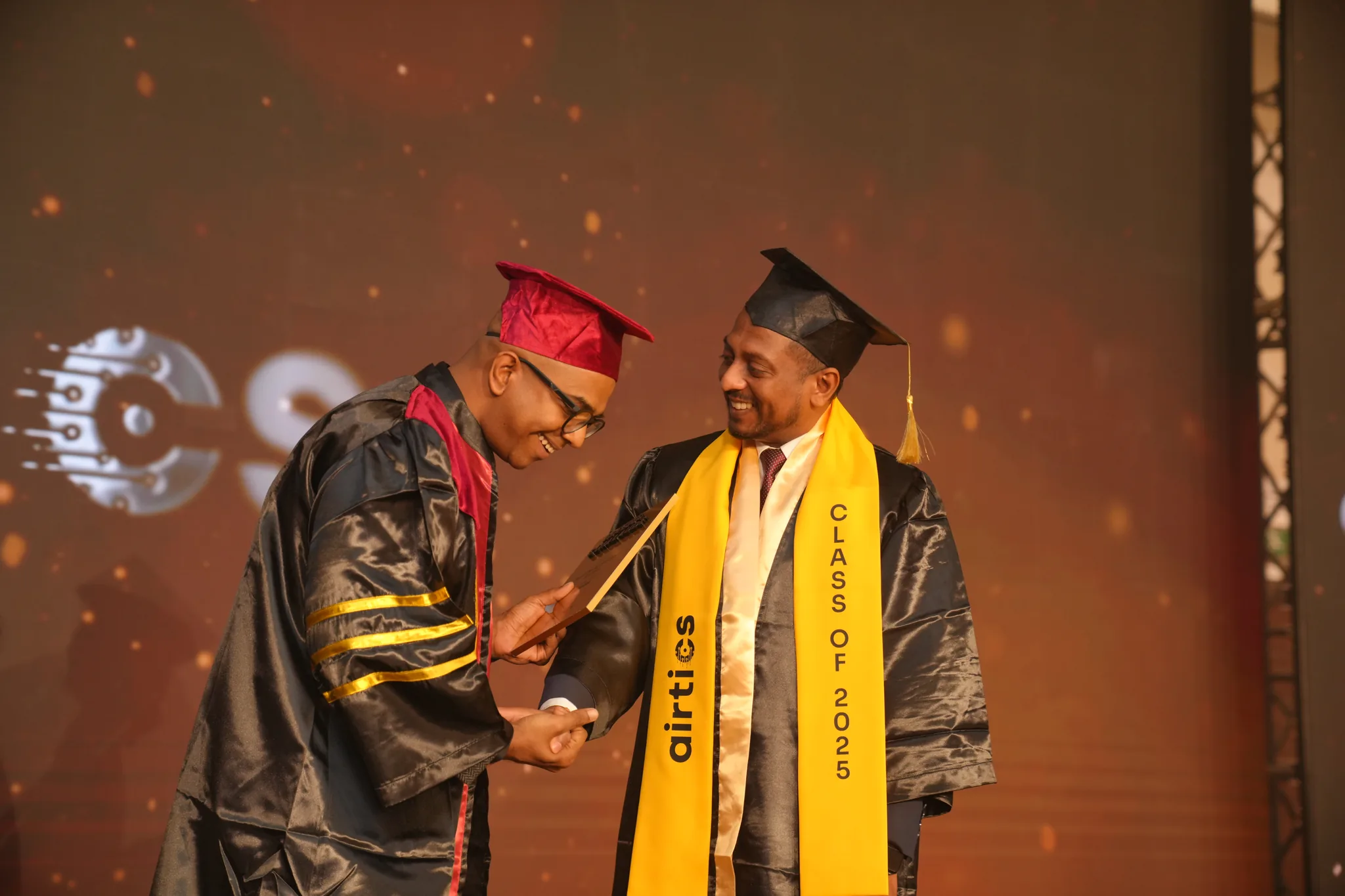 Airtics Graduation 2026: graduate being hooded on stage during the Airtics convocation ceremony