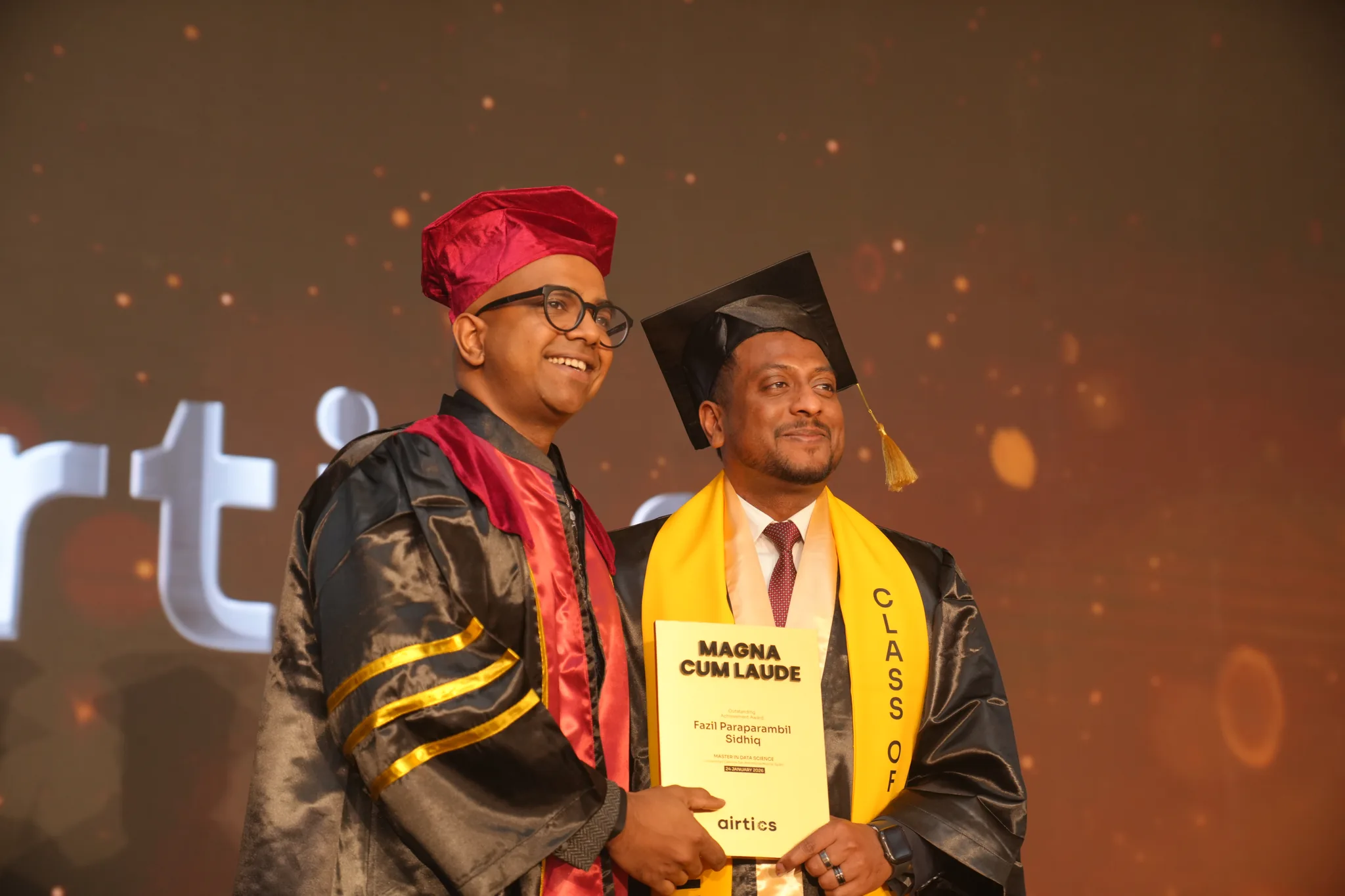 Airtics Graduation 2026: graduate receiving their certificate on stage from the Airtics academic panel
